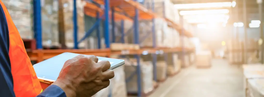 Person reviewing boxes to be shipping in a factory